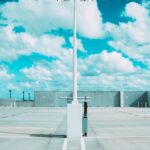 white and black metal stand under white clouds and blue sky during daytime