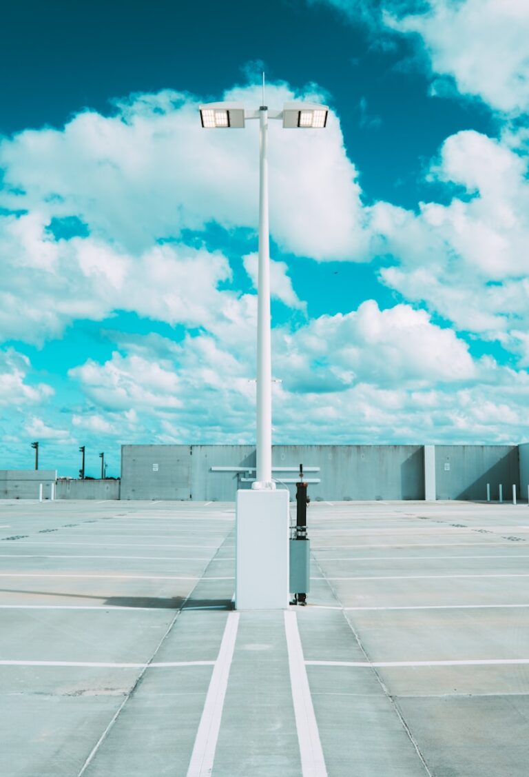 white and black metal stand under white clouds and blue sky during daytime